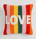Colorful striped pillow with the word 'LOVE' on a light gray background