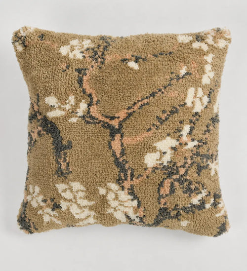 Decorative pillow with floral pattern on a plain background