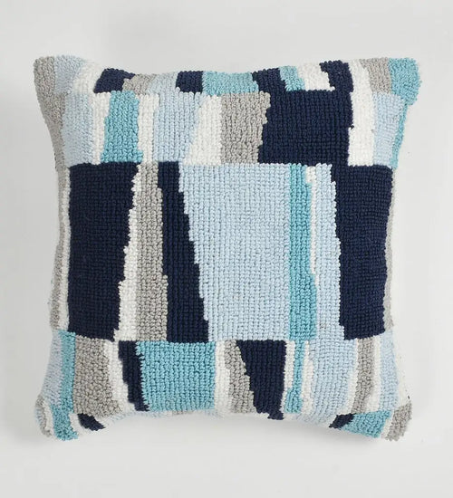 Textured pillow with geometric pattern on a light gray background